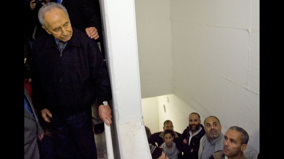 Israeli President Shimon Peres stands inside a shelter as a rocket warning siren blares in the southern Israel city of Ashkelon on December 31, 2008. Israel at the time had rejected mounting international pressure to suspend its devastating air offensive against Palestinian militants.