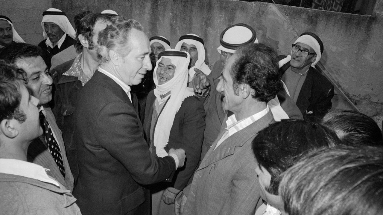 Defense Minister and acting Prime Minister Shimon Peres speaks with Israeli Arabs before Israelis go to the polls in Umm al-Fahm, Israel, on May 17, 1977 in the country's national elections.
