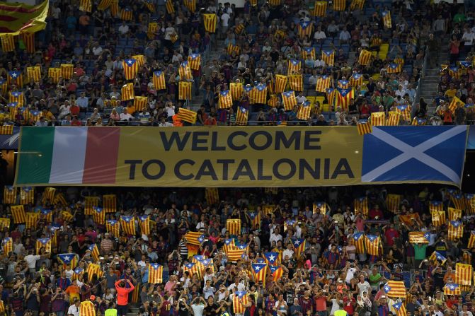 Barcelona fans hold up Catalan flags during the match against Celtic. The flag, known locally as the "Estelada," has in recent years become a symbol of the independence movement within Catalonia. UEFA outlaws the use of objects that transmit political messages. 