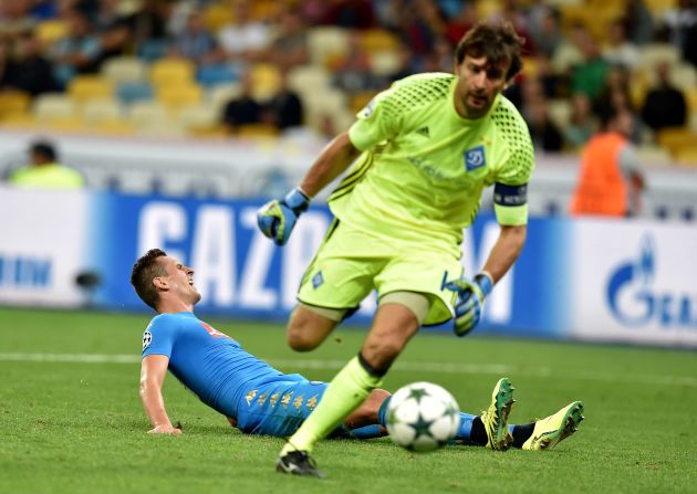 Dynamo Kiev goalkeeper Olexandr Shovkovskiy made history by becoming the second oldest player to contest a Champions League match but he was beaten twice by Arkadiusz Milik, pictured on the floor, as Napoli won 2-1. 