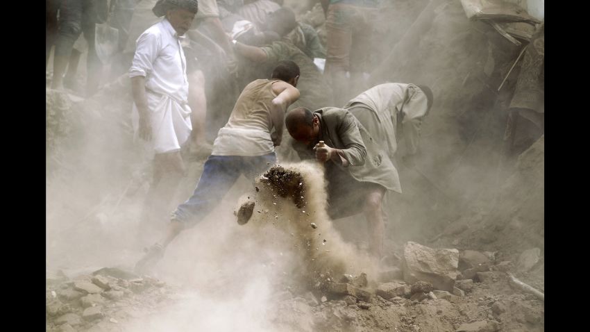 People search for survivors under the rubble of houses in Sanaa, Yemen, in June 2015 following an airstrike.