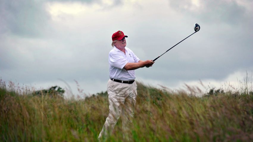 US tycoon Donald Trump plays a stroke as he officially opens his new multi-million pound Trump International Golf Links course in Aberdeenshire, Scotland, on July 10, 2012. Work on the course began in July 2010, four years after the plans were originally submitted.  AFP PHOTO / Andy Buchanan        (Photo credit should read Andy Buchanan/AFP/Getty Images)