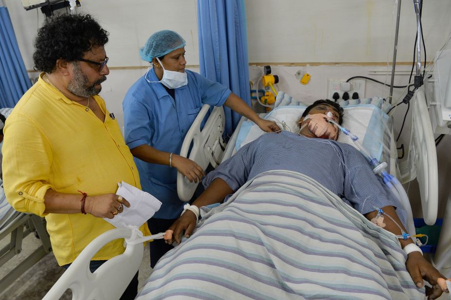 A family friend and a nurse attend to Kumar, a 32-year-old patient in a private hospital in Bangalore. Kumar was injured in the violence that erupted following the Cauvery water dispute.