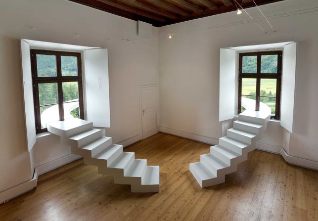 The two curved stairs, just 70 cm (28 inches) wide, ascend to windows that lead out to a walkway that wraps around the building's external facade. 