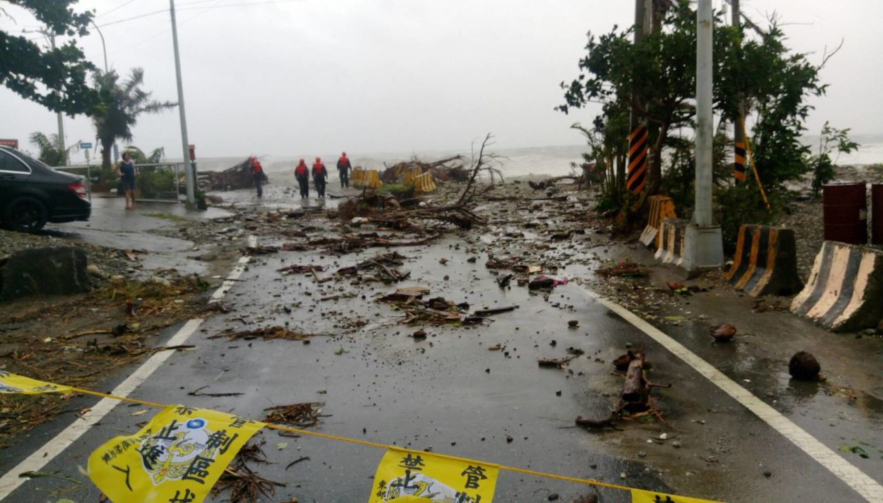 Recovery workers survey storm damage near Fugang in southern Taiwan. 