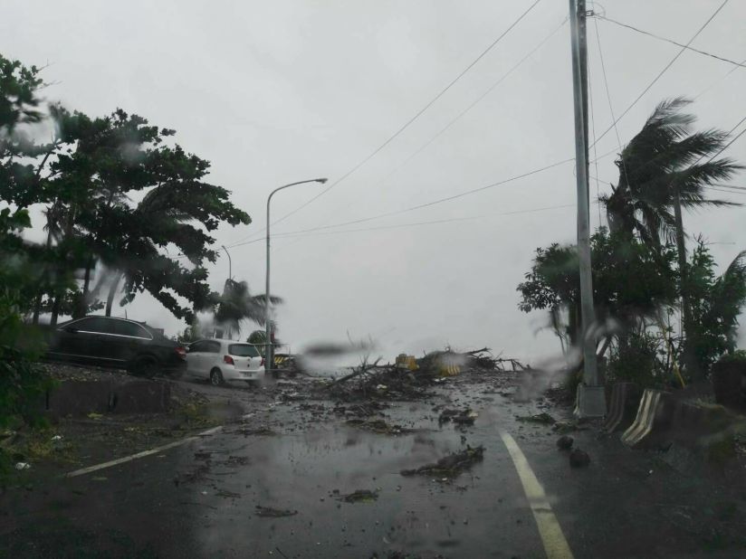 Roads blocked by fallen branches amid heavy winds and lashing rain in southern Taiwan. 