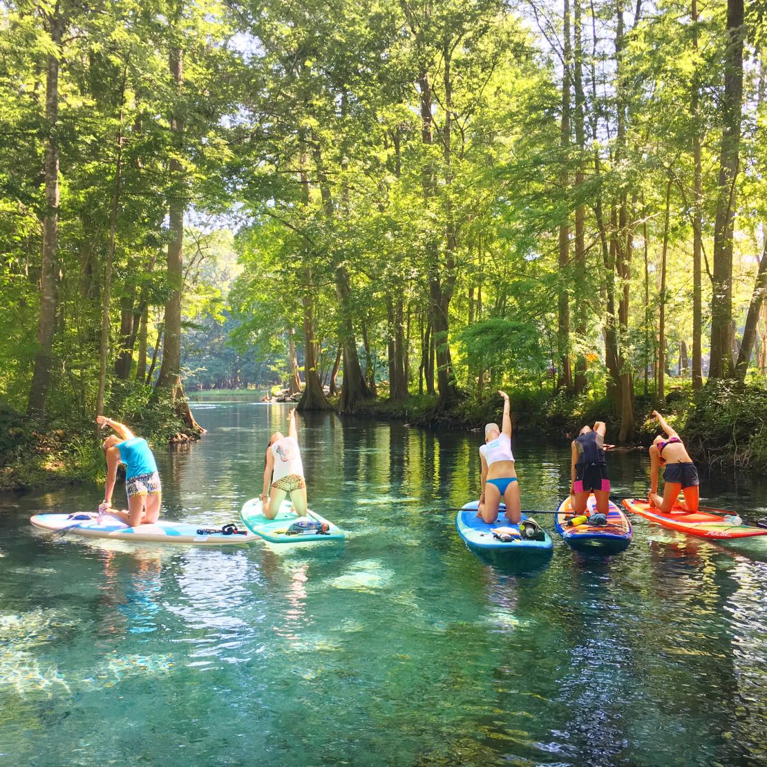 Paddleboard yoga provides a serene alternative to water parks.