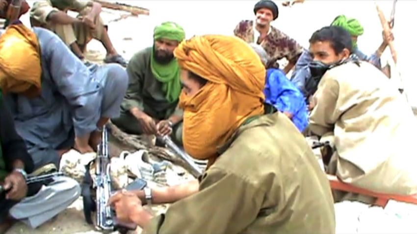 A still from a video shows Islamist militants sitting on the ground with their weapons after destroying an ancient shrine in Timbuktu on July 1, 2012. Islamist rebels in northern Mali smashed four more tombs of ancient Muslim saints in Timbuktu on July 1 as the International Criminal Court warned their campaign of destruction was a war crime. The hardline Islamists who seized control of Timbuktu along with the rest of northern Mali three months ago, consider the shrines to be idolatrous and have wrecked seven tombs in two days. AFP PHOTO (Photo credit should read STR/AFP/GettyImages)