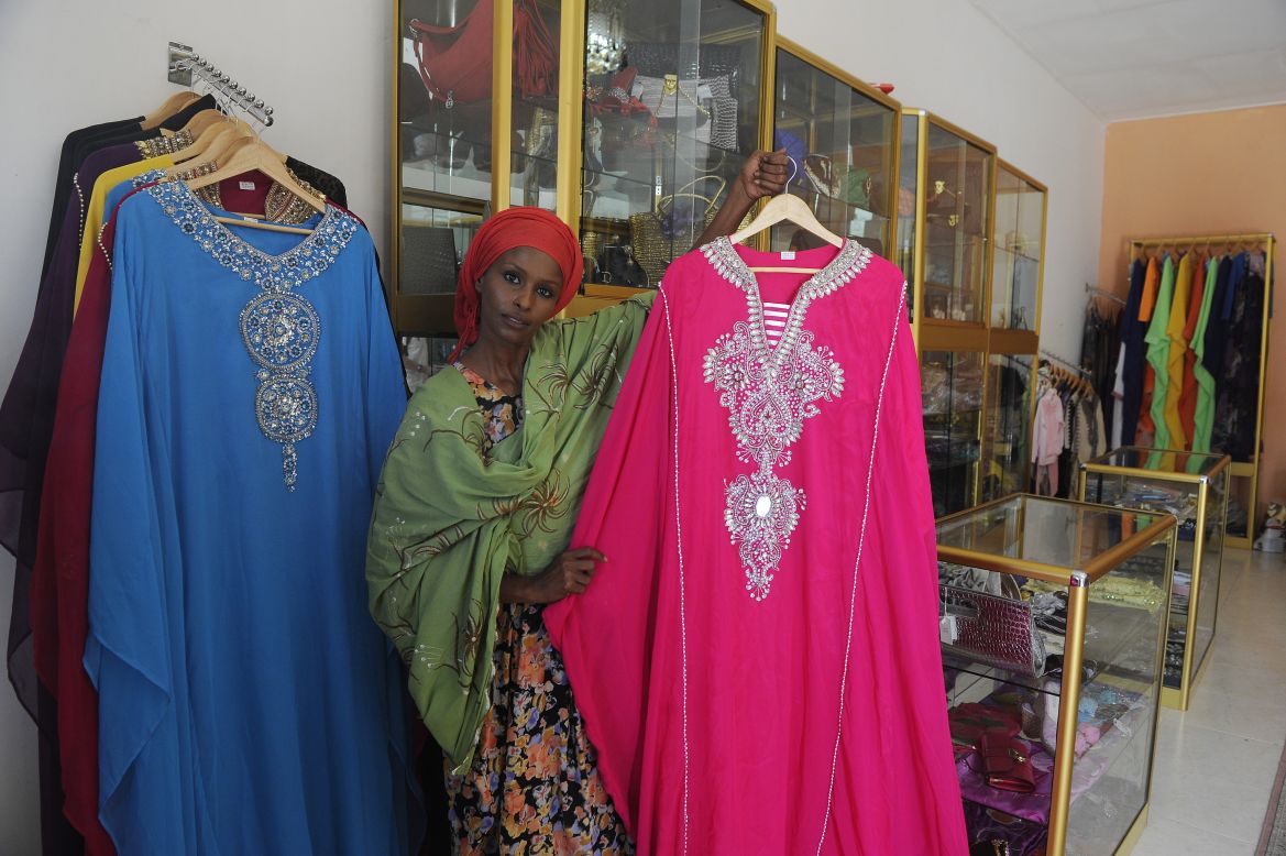 Ayan Hussein, a London stylist originally from Somaliland, shows dresses she sells to local Muslim women, inside her clothing store in Hargeisa. Hussein is one of many immigrants who have found their way back to the relative calm of Somaliland. 