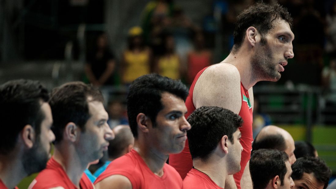 Iran's tallest man, sitting volleyball player Morteza Mehrzadselakjani stands with teammates before a preliminary match against Ukraine Wednesday. 