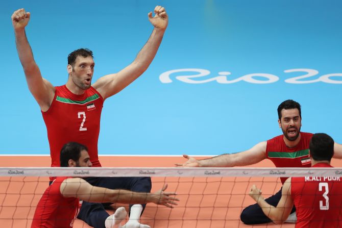 Sitting down, his outstretched arms reach more than six feet from the ground.