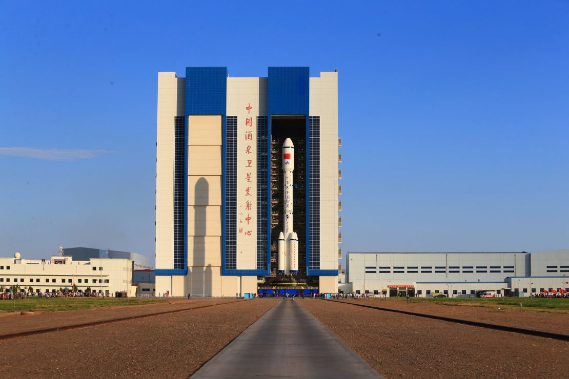 The Long March 2F carrier rocket is carried to the launch tower last week. 