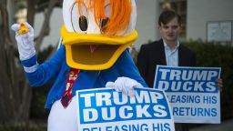 A protester dress like Donald Duck hands out "Trump Ducks" while protesting Republican presidential nominee Donald Trump's lack of tax returns released to the public outside the Republican National Committee headquarters in Washington, DC, September 13, 2016. / AFP / JIM WATSON          (Photo credit should read JIM WATSON/AFP/Getty Images)