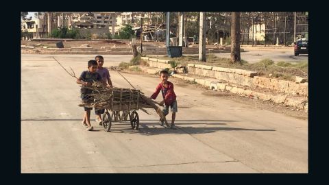 Children pushing cart loaded with firewood they collected in the Shihan neighborhood.