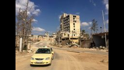 A taxi driving out of a formally rebel-controlled area near Castello Road.