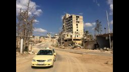 A taxi driving out of a formally rebel controlled area near Castello road in Aleppo.