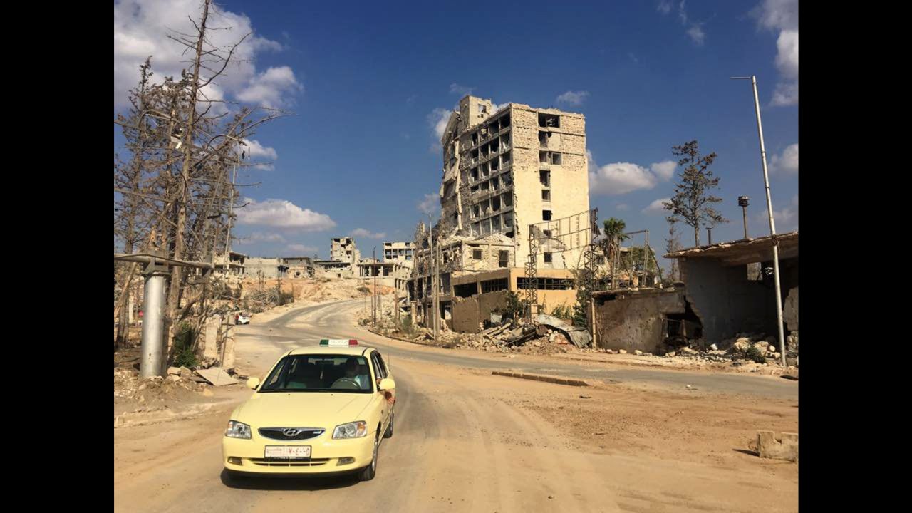A taxi driving out of a formally rebel-controlled area near Castello Road.