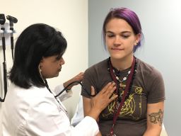 Dr. Sri Edupuganti does a physical exam of vaccine volunteer Virginia Bliss.