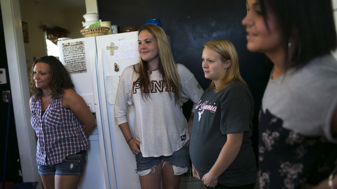 The rates of heroin addiction affect men and women equally in Huntington, health officials say. Here, women gather in the kitchen where they prepare dinner for each other at a Lifehouse facility.