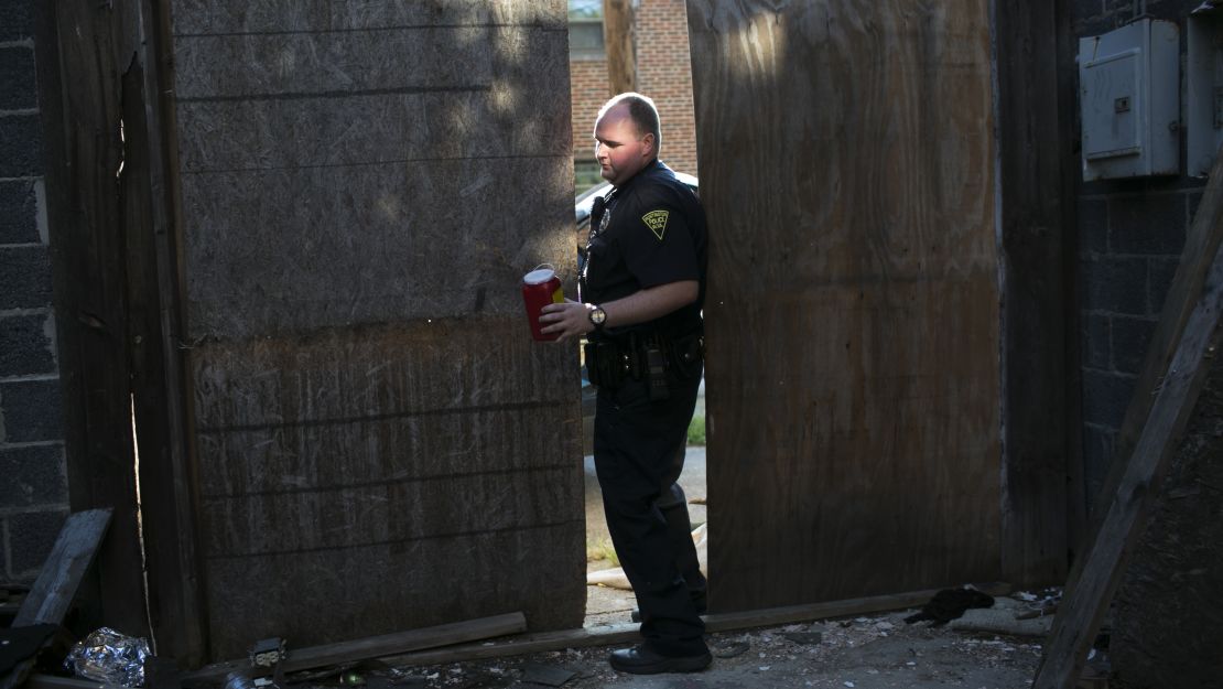 Patrolman Jacob Felix collects dirty needles at Marcum Terrace. Two officers, three firefighters and two EMS workers respond to every overdose.