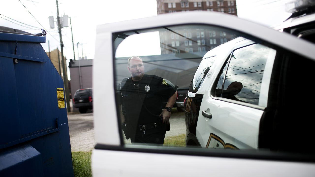 Patrolman Jacob Felix prepares to go out on a call. More than 50% of his job, he says, is responding to heroin overdoses.