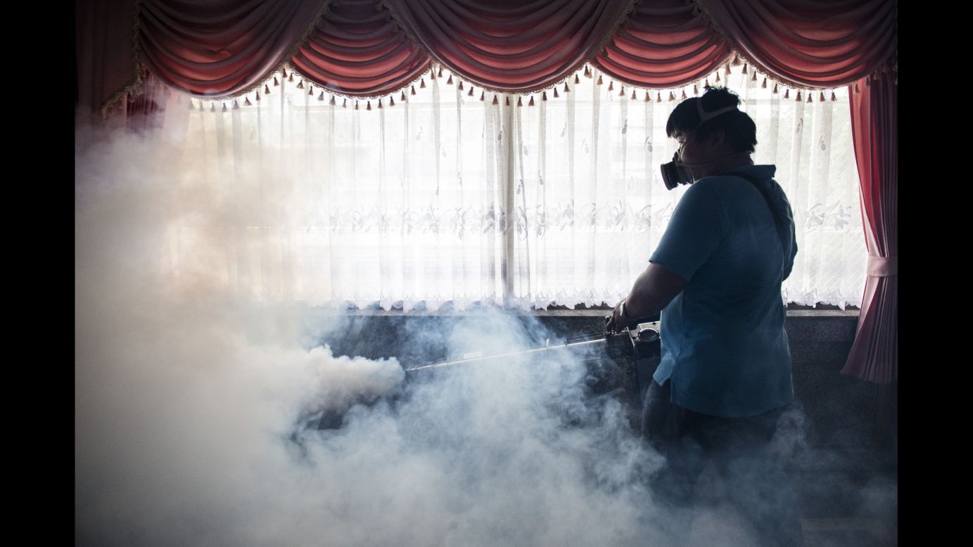 A worker sprays chemicals to kill mosquitoes in an effort to control the spread of the Zika virus at a school in Bangkok, Thailand, on Wednesday, September 14.