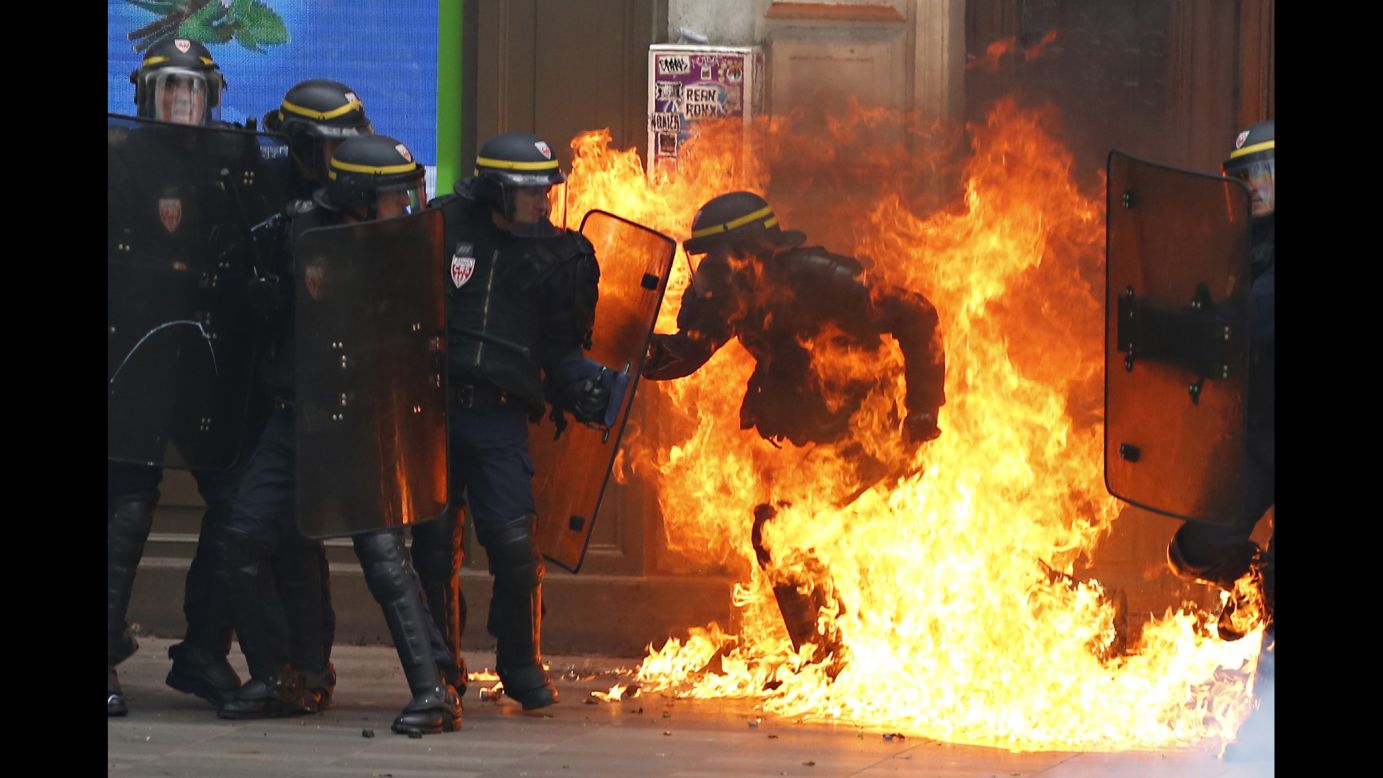 A riot police officer is surrounded by flames during a demonstration against new labor law reforms in Paris on Thursday, September 15. <a href="http://www.cnn.com/2016/06/02/europe/france-strikes-labor-reform-bill/index.html" target="_blank">Demonstrations against the reforms</a> -- which include changes in the number of hours staff are expected to work and easier means for companies to hire and fire people -- have been taking place for about six months throughout France.