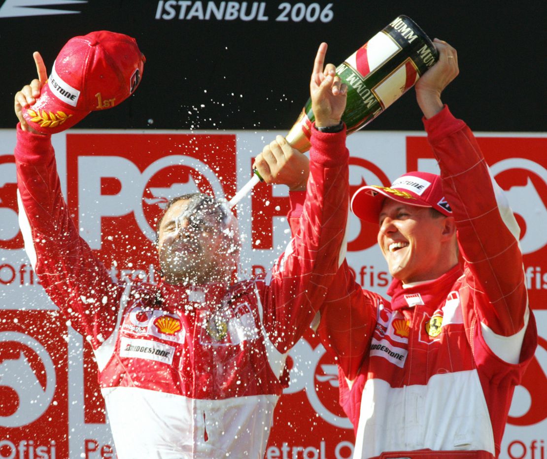 Massa is sprayed by the great Michael Schumacher as the Brazilian celebrates his first grand prix win. 