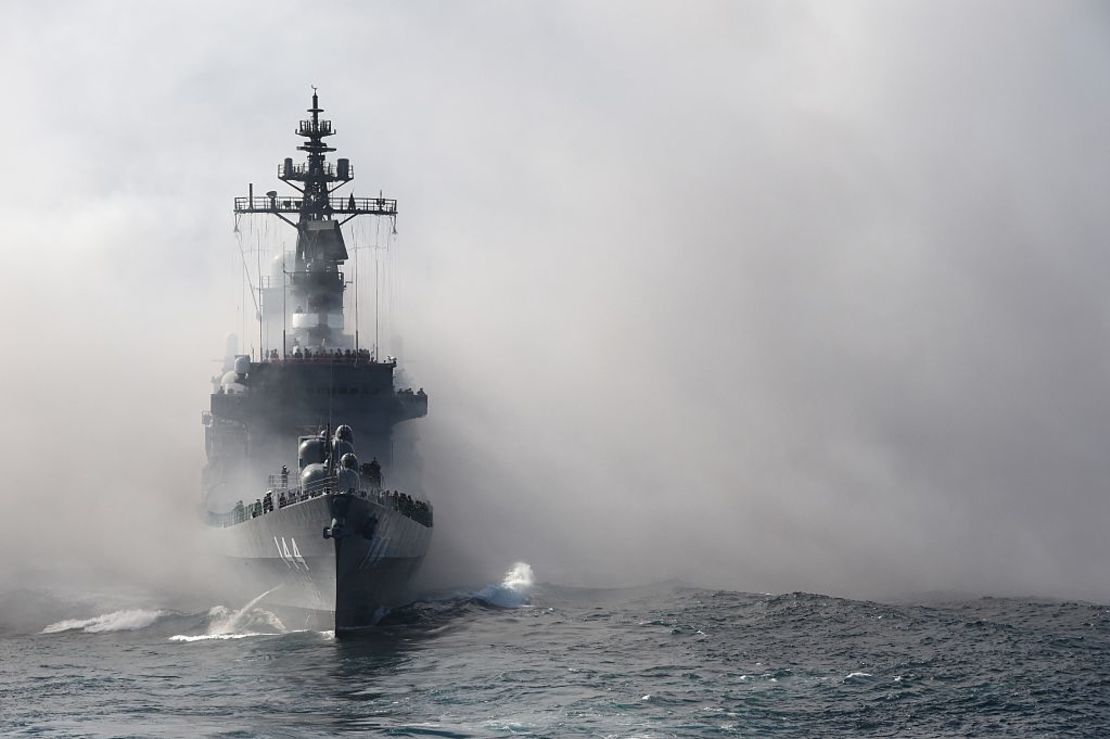 Japan's Maritime Self-Defense Force (MSDF) escort ship Kurama sails through smoke during a fleet review off Sagami Bay, Kanagawa prefecture, on October 18, 2015.