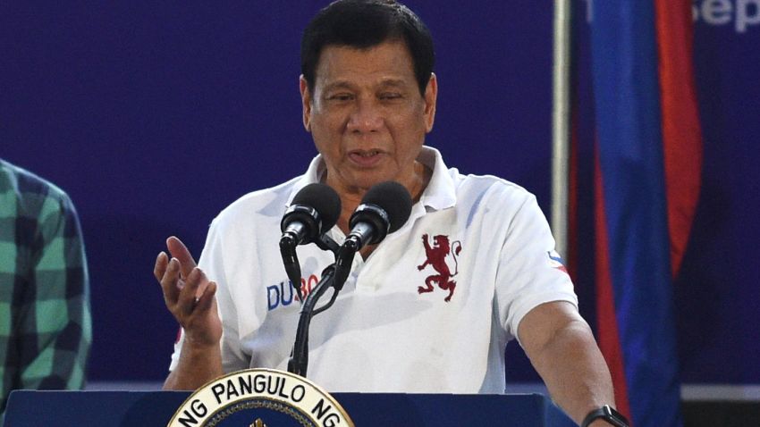 Philippine President Rodrigo Duterte (C) delivers a speech before members of the Scout Rangers regiment at a military training camp in San Miguel town, Bulacan province, north of Manila on September 15, 2016, while Secretary of Defense Delfin Lorenzana (L) and military chief Genral Ricardo Visaya look on.  
Rodrigo Duterte shot dead a justice department employee and ordered the murder of opponents, a former death squad member told parliament September 15, in explosive allegations against the Philippine president. / AFP / TED ALJIBE        (Photo credit should read TED ALJIBE/AFP/Getty Images)