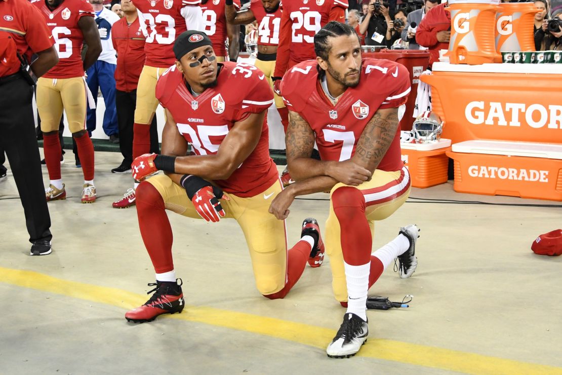 Colin Kaepernick, right, and Eric Reid of the San Francisco 49ers kneel in protest during the National Anthem before playing the Los Angeles Rams on September 12, 2016.