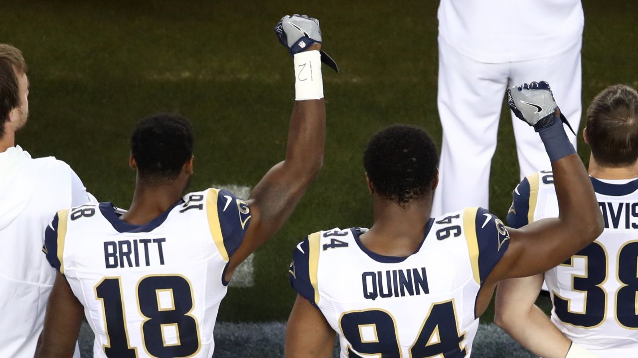 Kenny Britt #18 and Robert Quinn #94 of the Los Angeles Rams raise their fists in protest prior to playing the San Francisco 49ers on September 12, 2016 in Santa Clara, California.