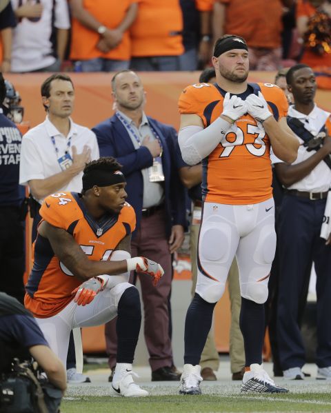 Denver Broncos' Brandon Marshall  kneels on the sideline during the national anthem before a game against the Carolina Panthers in Denver on September 8, 2016.