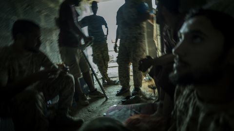 Libyan forces take shelter in a derelict district close to the front line. 