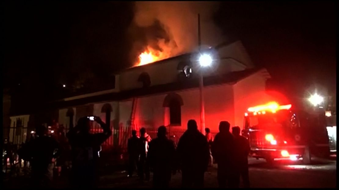 Flames engulf the church's roof in video from Peru TV network Andina. 