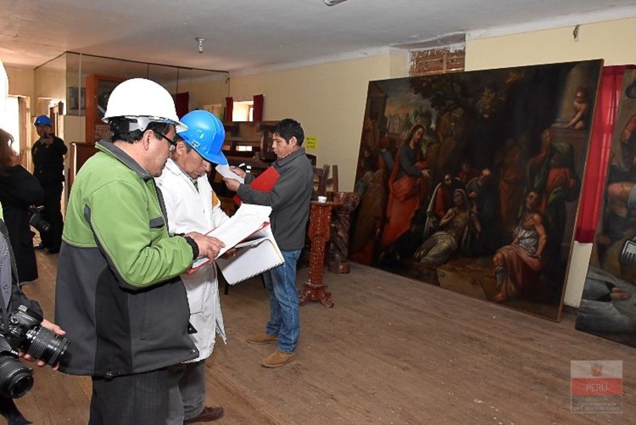Peruvian Ministry of Culture officials inspect damage to artwork at San Sebastian Church. The fire consumed priceless works from the so-called Cuzco School of Roman Catholic art.