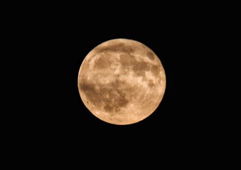 "With a beautiful full moon that was glowing orange on a clear night, I had to take advantage and get some photos," Faith Konidaris of Pittsburgh says. 