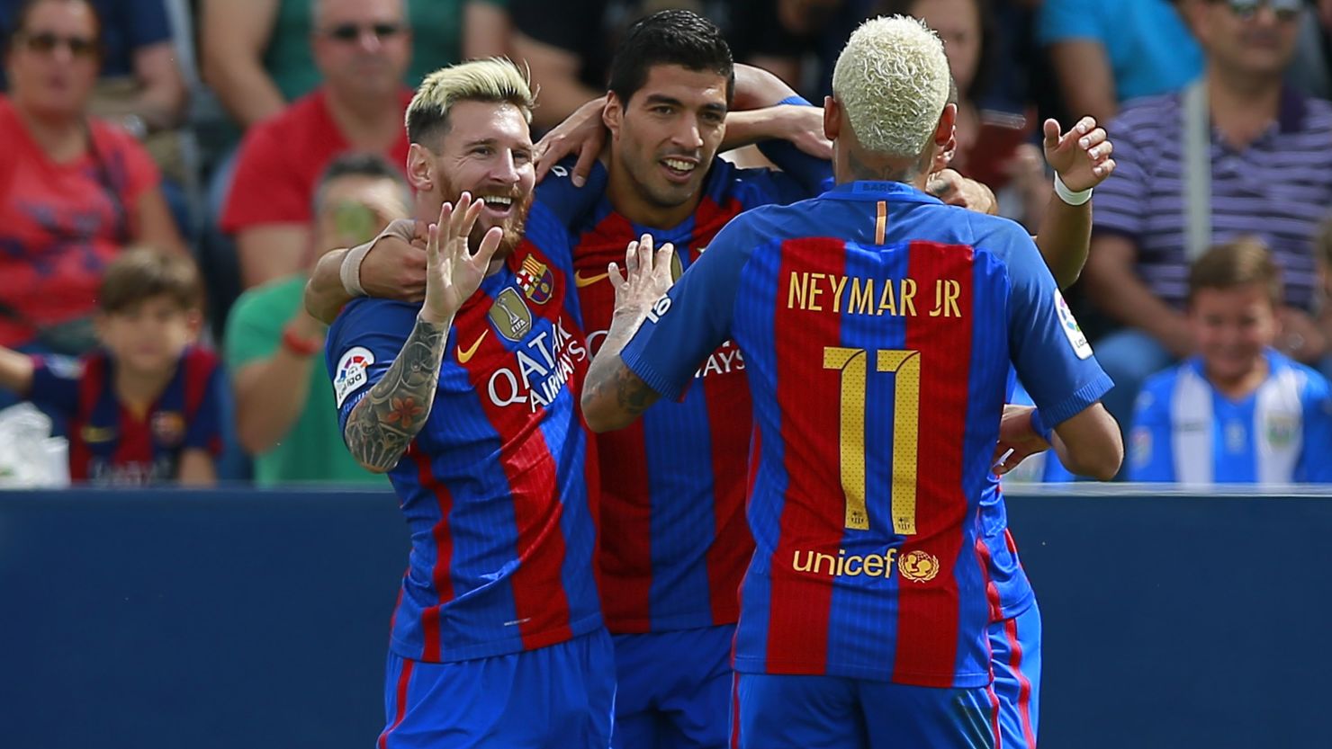 Lionel Messi celebrates Barcelona's opening goal with Luis Suarez and Neymar.
