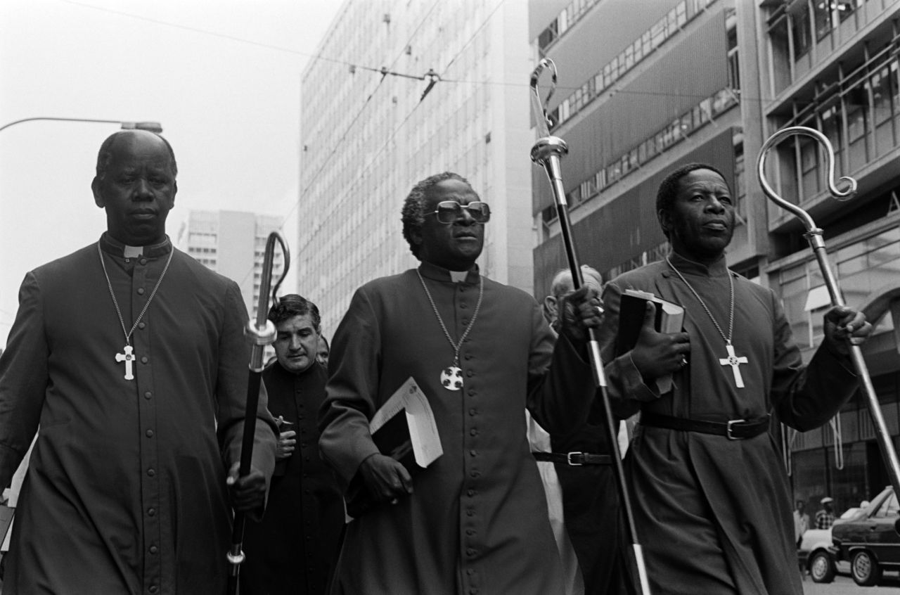 Tutu, center, leads clergymen through Johannesburg in April 1985. They were heading to police headquarters to hand a petition calling for the release of political detainees.     