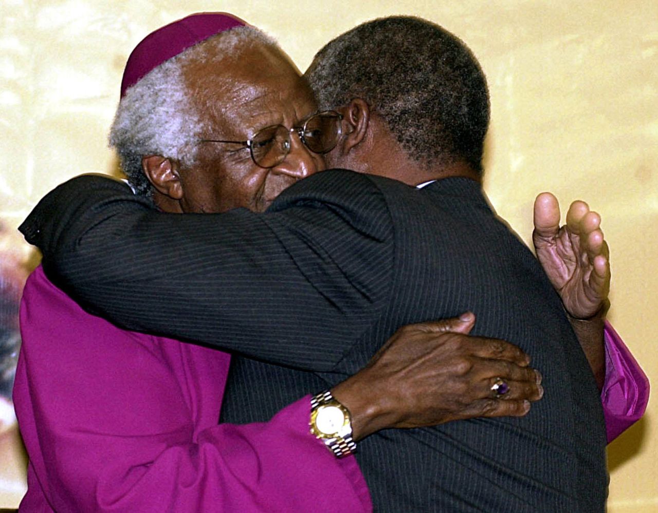 Tutu hugs South African President Thabo Mbeki after turning over the Truth and Reconciliation Report in 2003. Tutu chaired the commission that produced the report.