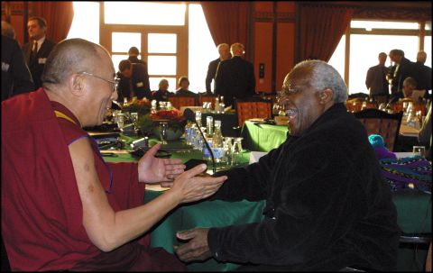 Tutu and the Dalai Lama attend the Nobel Peace Prize Centennial Symposium in 2001.