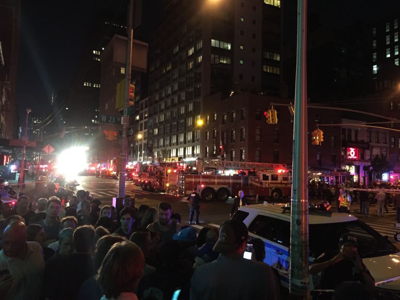 A crowd gathers near the site of the explosion. 