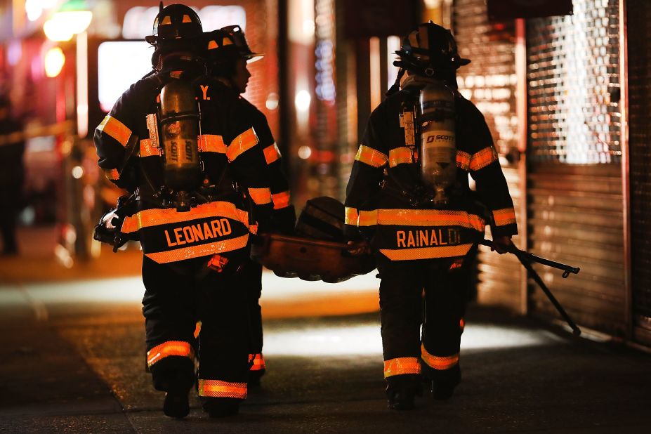 Firefighters and emergency workers gather at the scene.