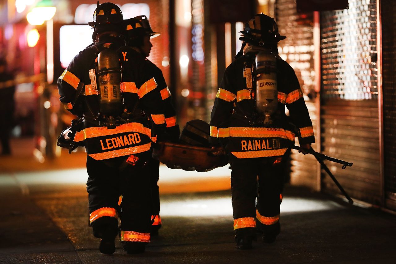 Firefighters and emergency workers gather at the scene.