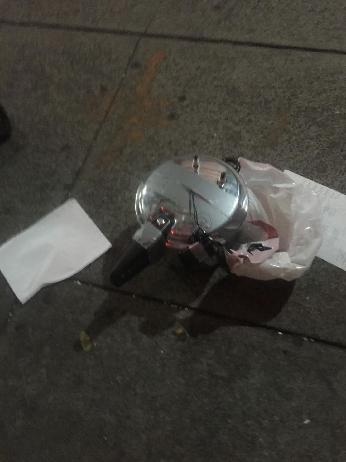 A suspicious device at a second location in Chelsea appears to be a pressure cooker with dark-colored wiring coming out of its top. 