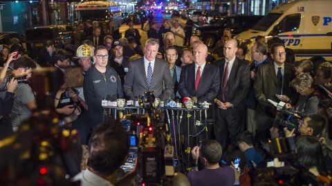 Mayor Bill de Blasio, center, and New York Police Commissioner James O'Neill, center right, speak during a press conference near the scene of an explosion on West 23rd street in Manhattan's Chelsea neighborhood, in New York, Saturday, Sept. 17, 2016. 