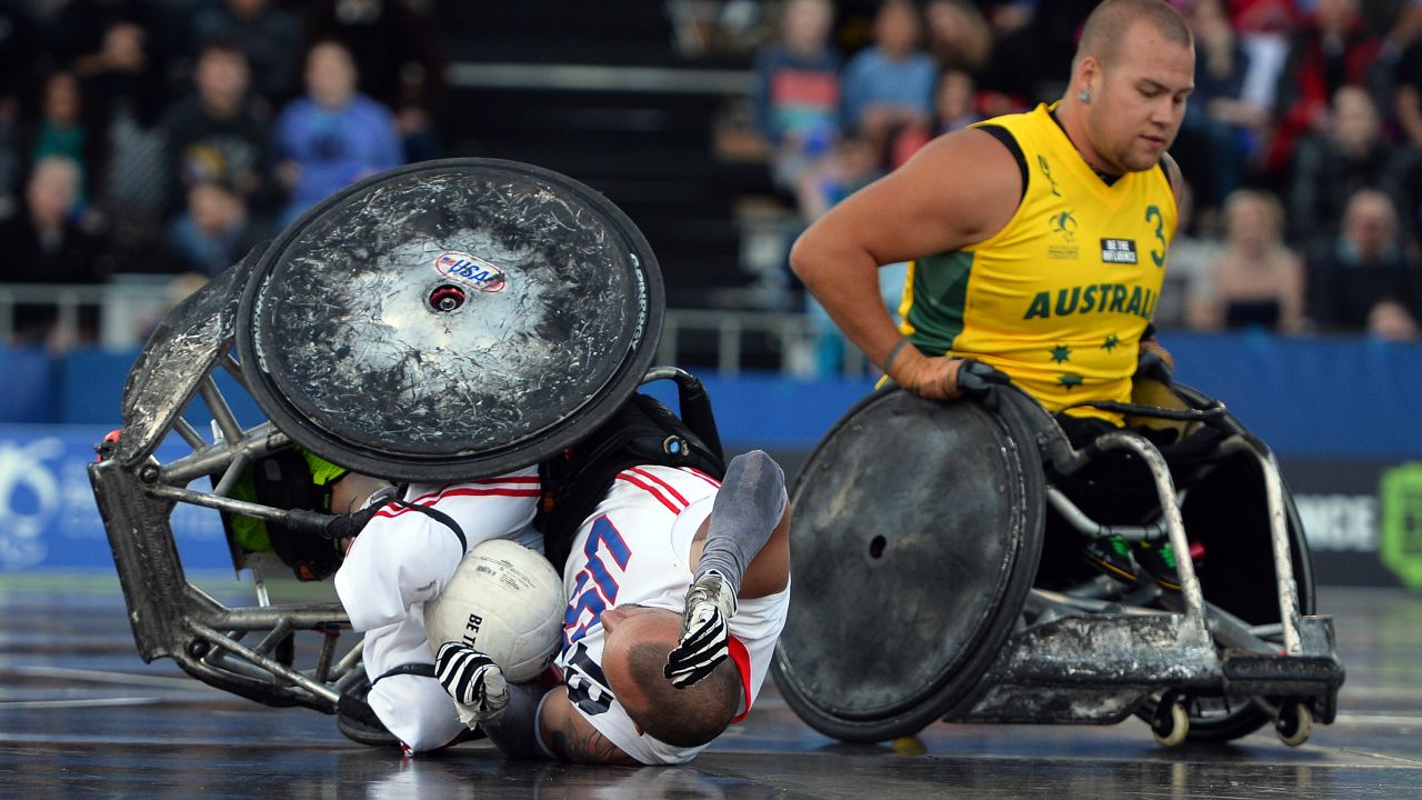 A collision with Batt leaves US player Derrick Helton on the floor during the Wheelchair Rugby Tri-Nations final in Sydney, 2013.