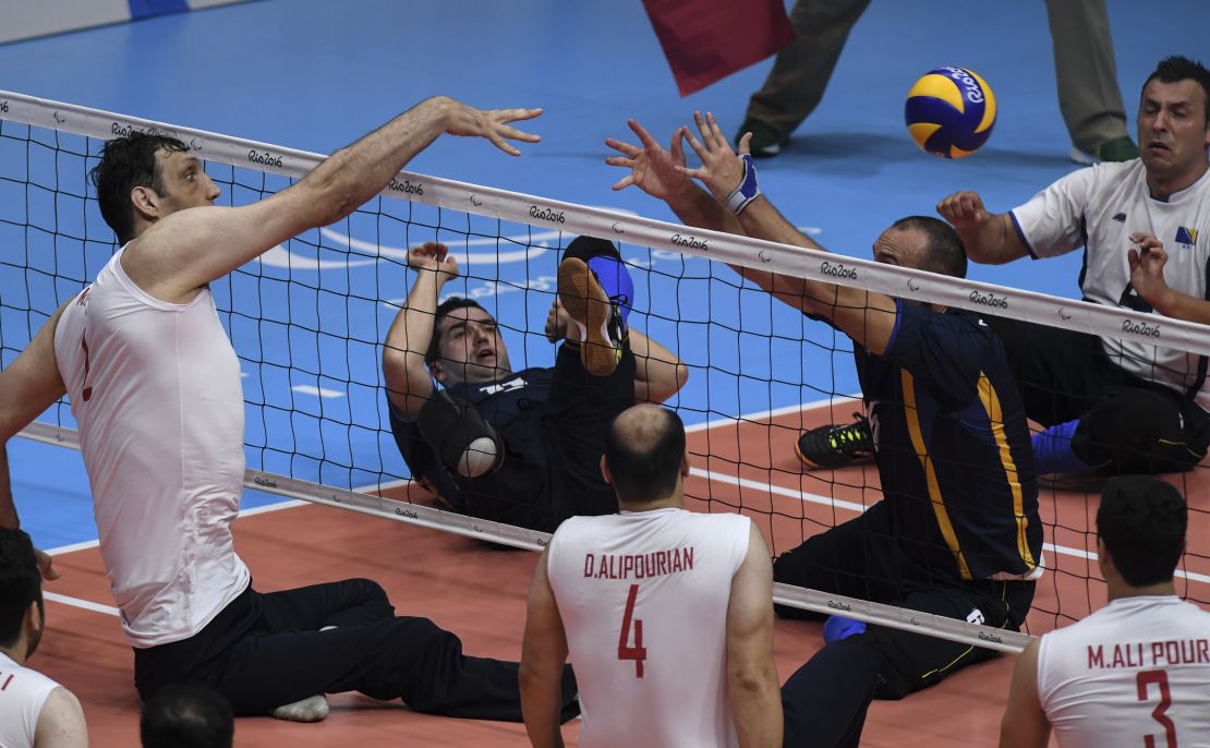 Morteza Mehrzadselakjani (L) of Iran competes during the sitting volleyball gold medal match between Iran and Bosnia and Herzegovina.