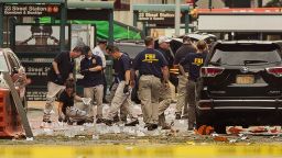 Members of the Federal Bureau of Investigation (FBI) carry on investigations at the scene of Saturday's explosion on West 23rd Street and Sixth Avenue in Manhattan's Chelsea neighborhood, New York, Sunday, Sept. 18, 2016. An explosion rocked the block of West 23rd Street between Sixth and Seventh Avenues at 8:30 p.m. Saturday. Officials said more than two dozen people were injured. Most of the injuries were minor. (AP Photo/Andres Kudacki)