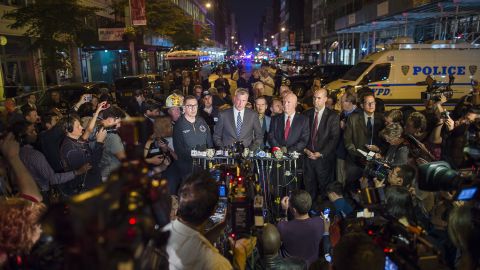 De Blasio, in the blue tie, speaks at a news conference near the scene on Saturday. He was joined by New York Police Commissioner James O'Neill.